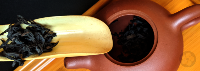scooping fresh leaves into a teapot for brewing keeps them from going stale in the cupboard