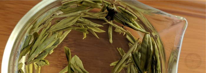 Young spring leaves pressed into a hot wok make up the dragonwell tea, steeping here in a glass server